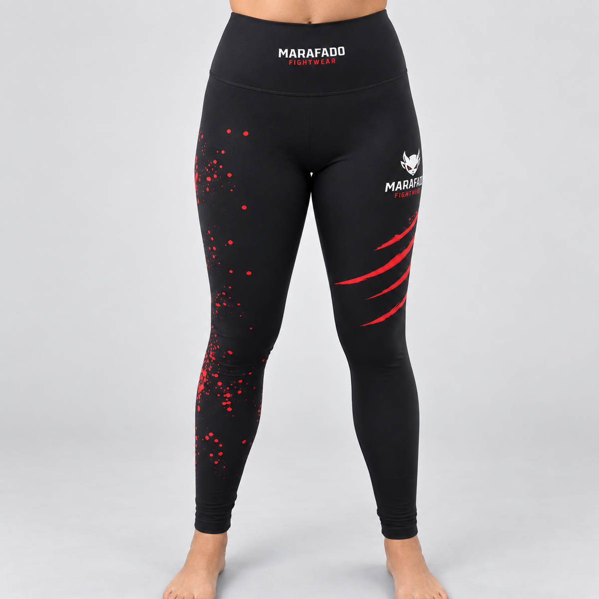 Leggings Hard to Handle pretas e vermelhas da Marafado Fightwear, vestidas por modelo feminino, vista de frente com cintura alta e detalhes vermelhos nas pernas.